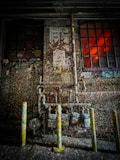 a fire hydrant in front of a building covered in graffiti