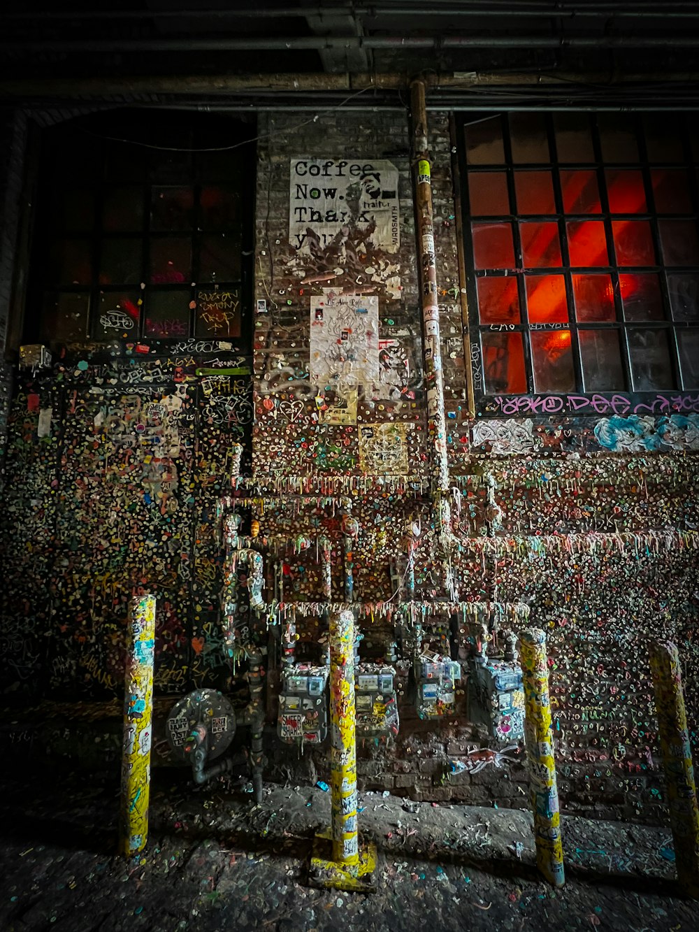 a fire hydrant in front of a building covered in graffiti