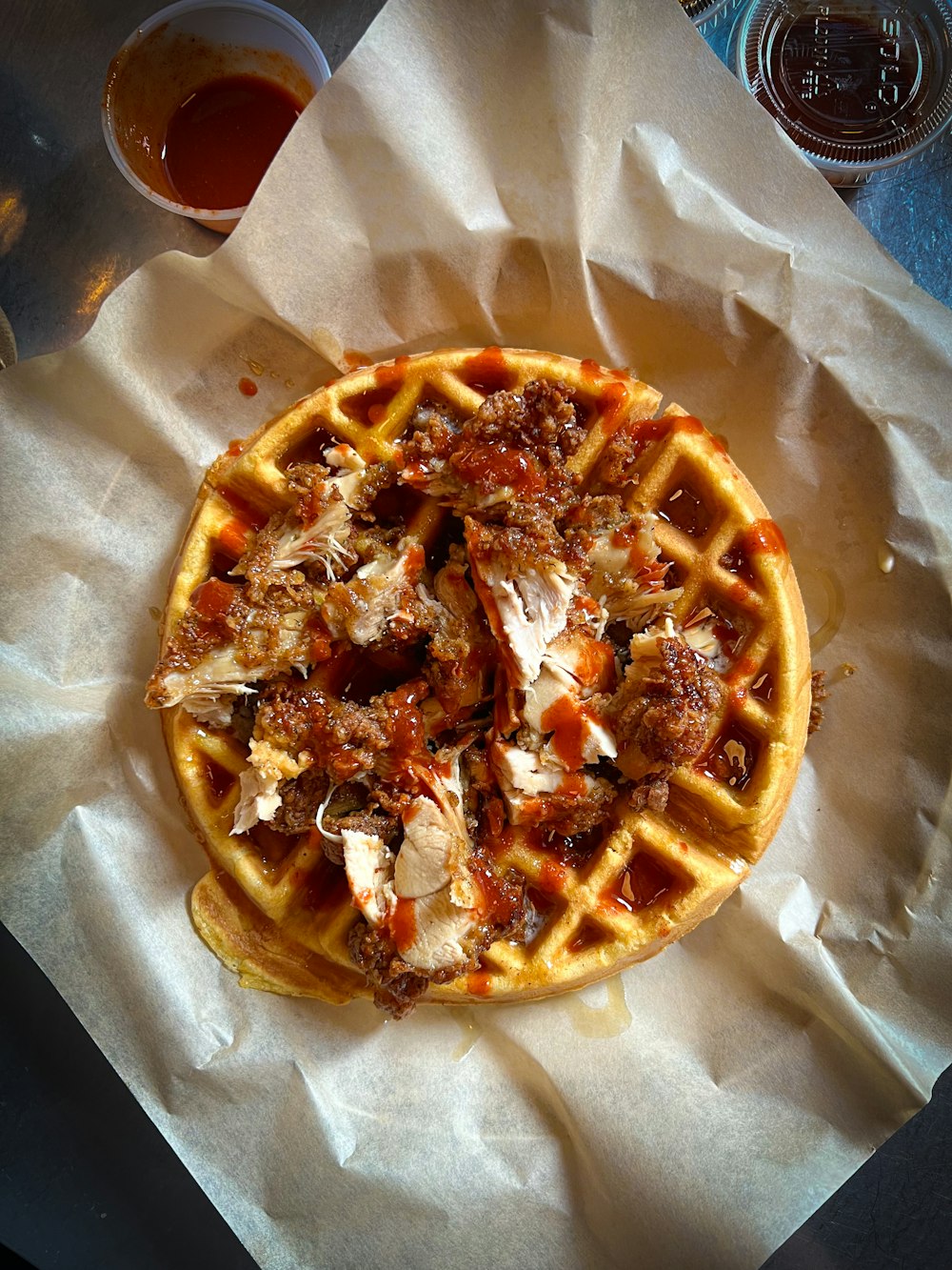 a waffle sitting on top of a piece of wax paper