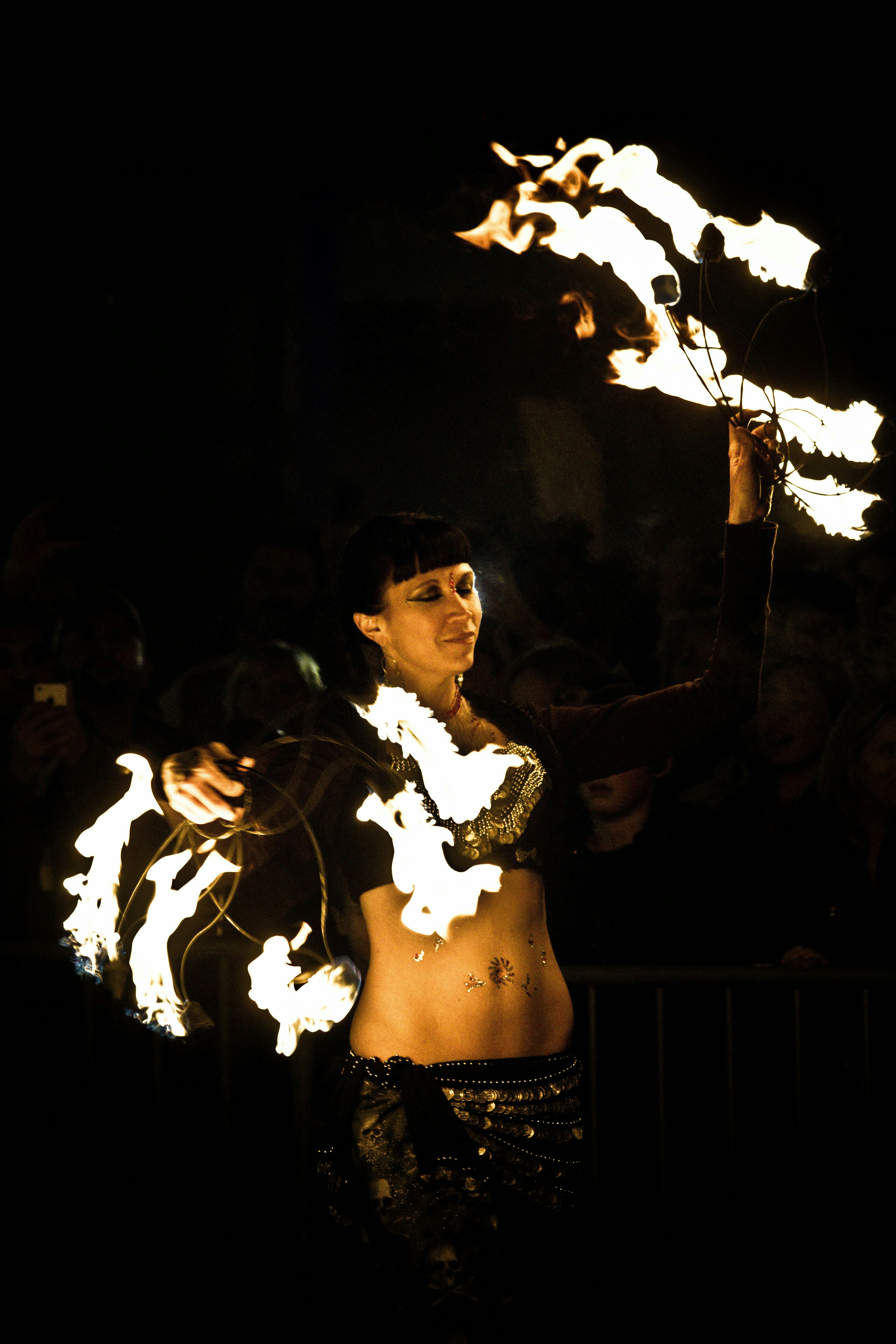 a woman in a bikini holding fire sticks