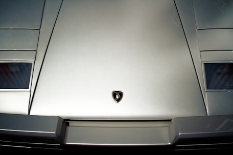 Image of a sleek car with a contract and pen on the hood, representing automotive credit options.