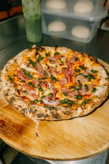 a pizza sitting on top of a wooden cutting board