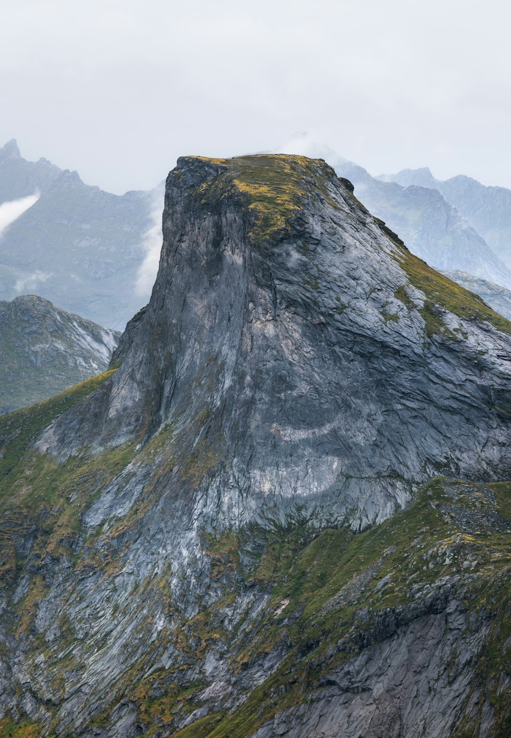 a large mountain with a very tall rock on top of it