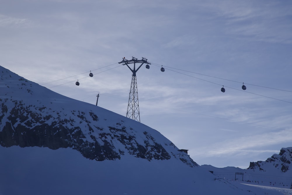 a ski lift going up a snowy mountain