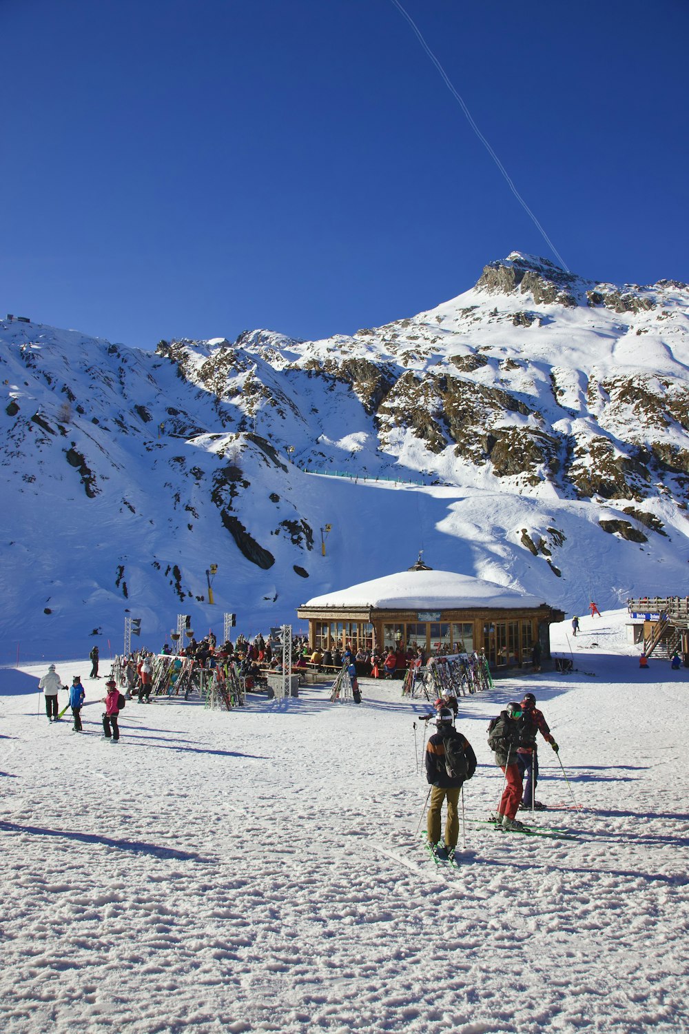 a group of people standing on top of a snow covered slope