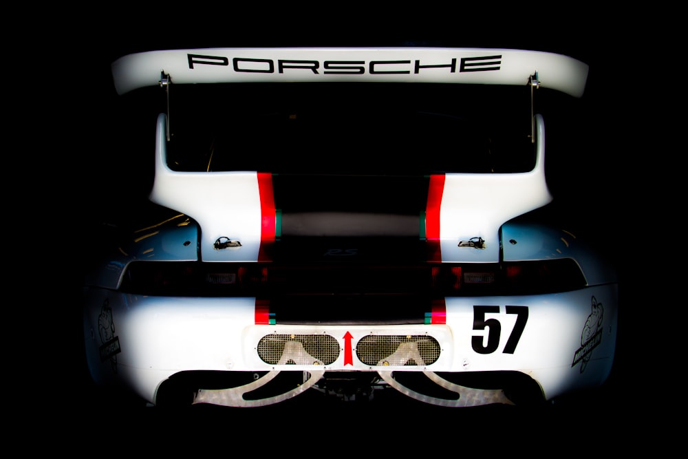 the front of a porsche sports car in the dark