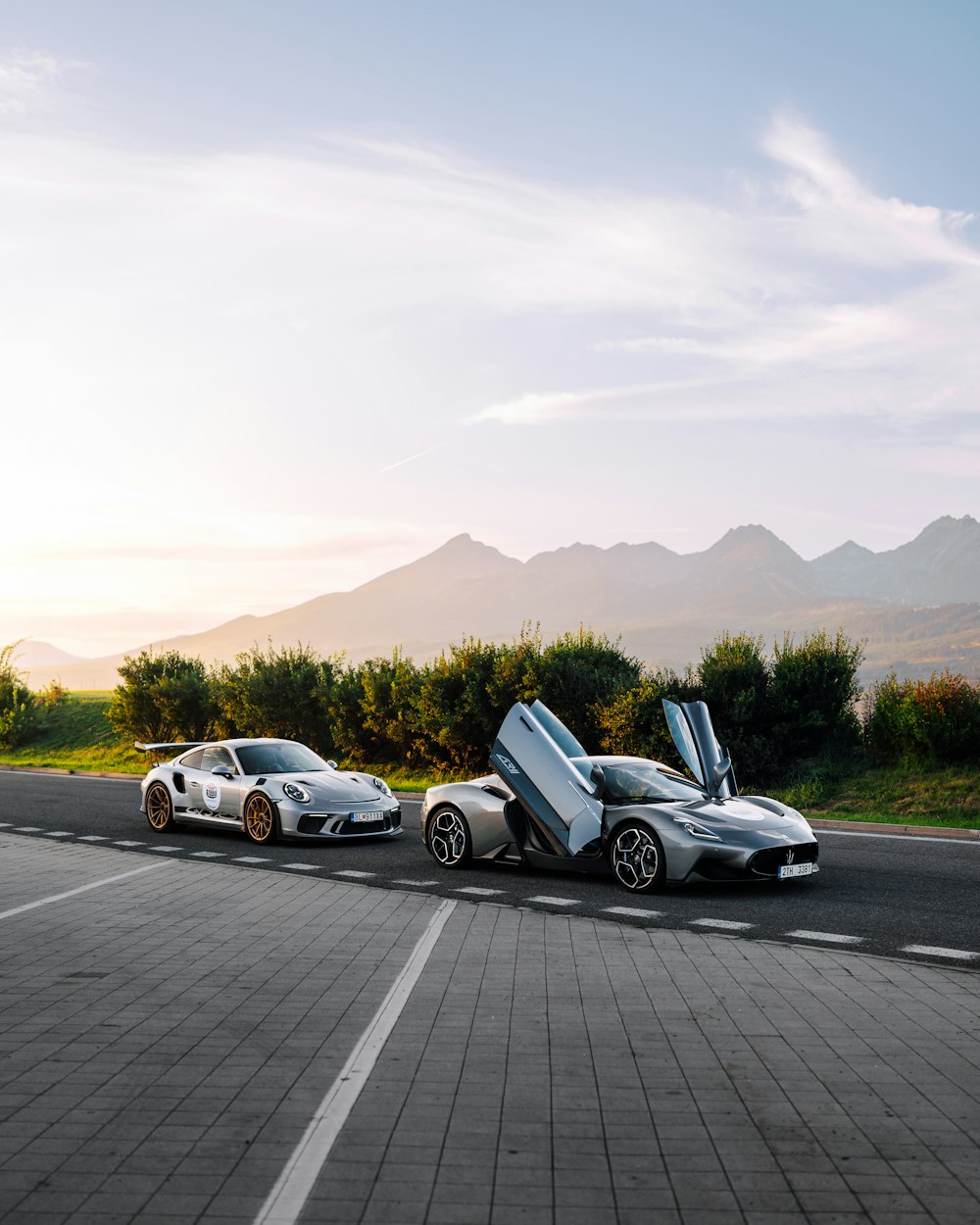 a couple of cars parked on the side of a road