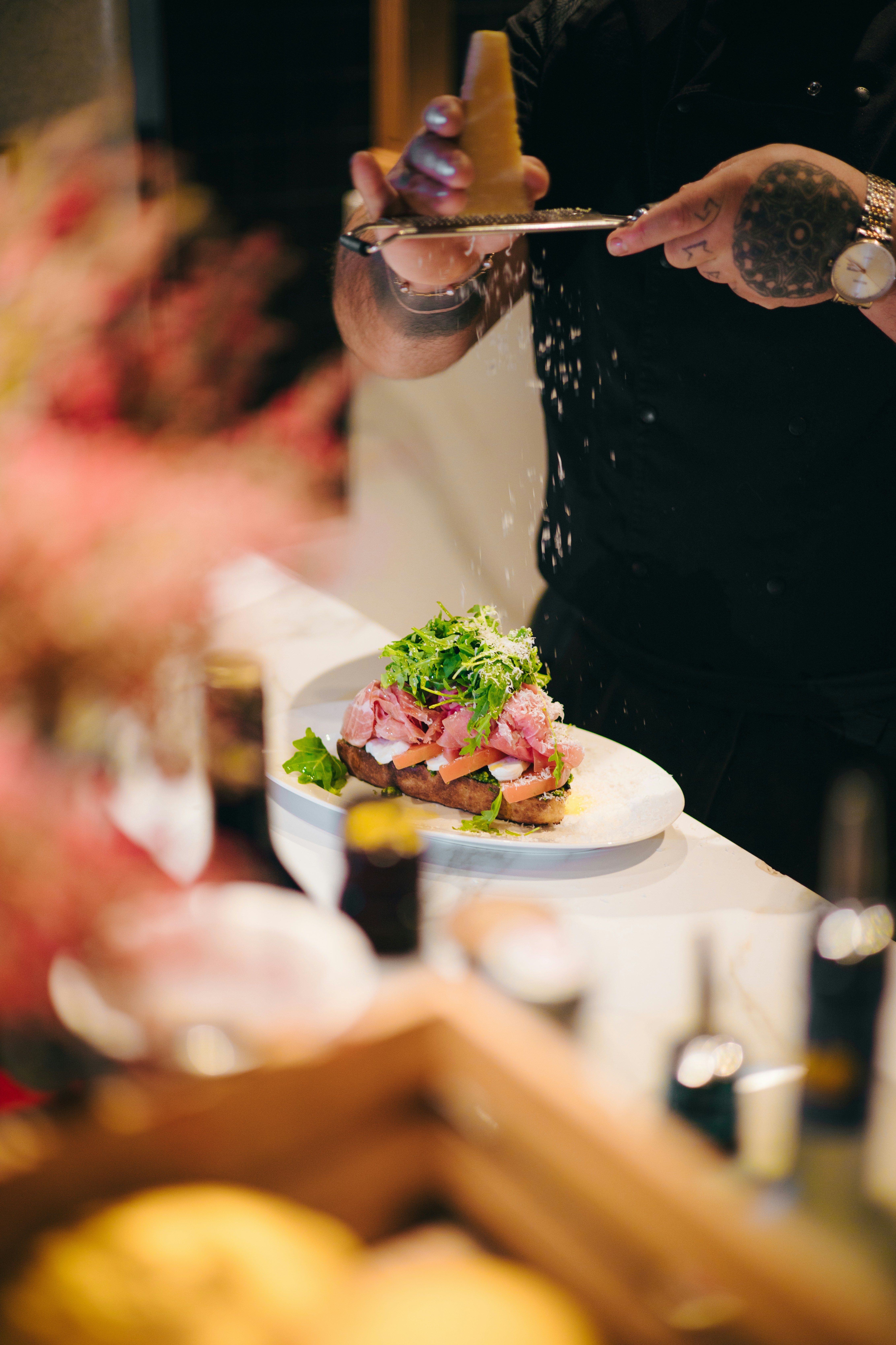 a man holding a knife and fork over a plate of food