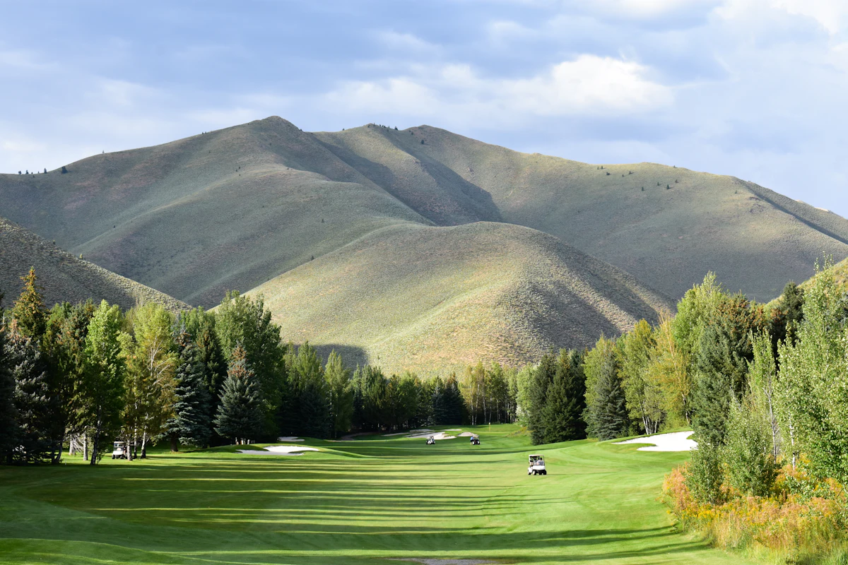 Sagebrush hills rising above a tree-lined fairway at the Sun Valley golf course