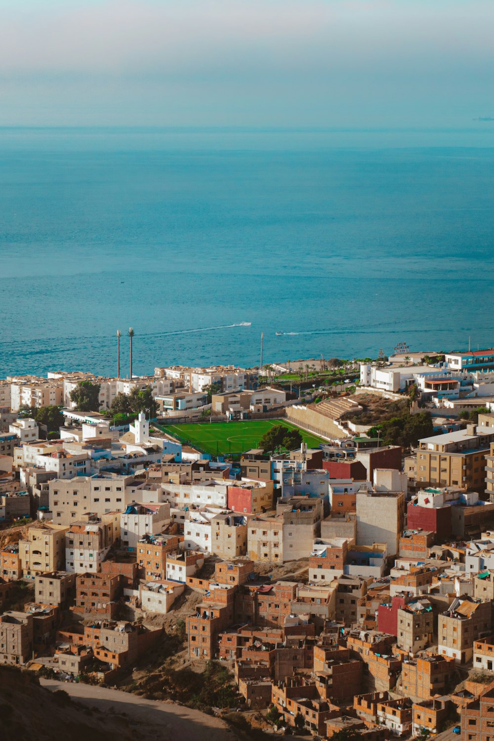 a view of a city with a body of water in the background