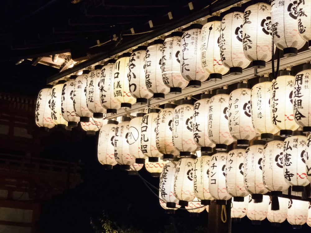a bunch of lanterns hanging from the ceiling