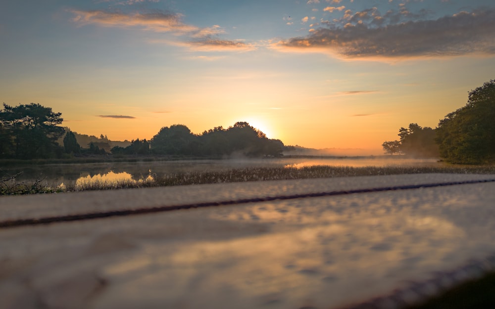 the sun is setting over a body of water