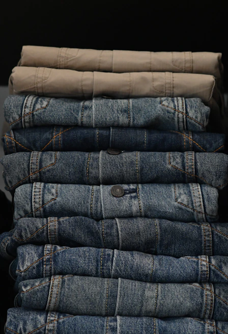 Rows of neatly folded chinos in stretch twill fabric ready for export packing.