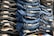 Neatly folded stacks of blue and black denim jeans are organized on display, showcasing tags on the folded edges.