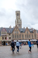 a group of people walking in front of a large building