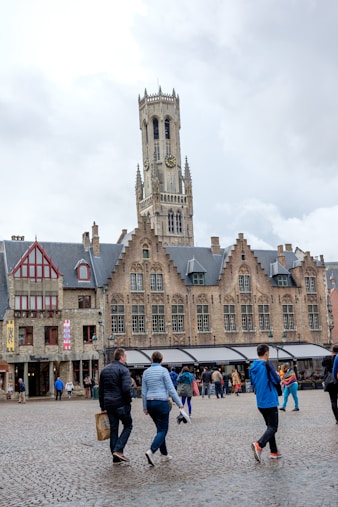 a group of people walking in front of a large building