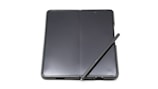 Android foldable device unfolded next to a windows laptop on a clean desk, highlighting seamless workflow integration.