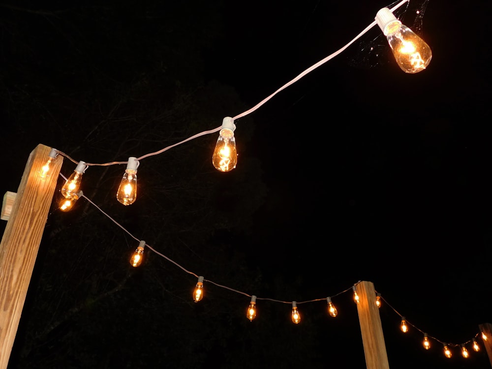 a string of lights hanging from a wooden post