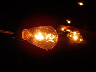 Close-up of a modern LED bulb glowing warmly in a cozy room