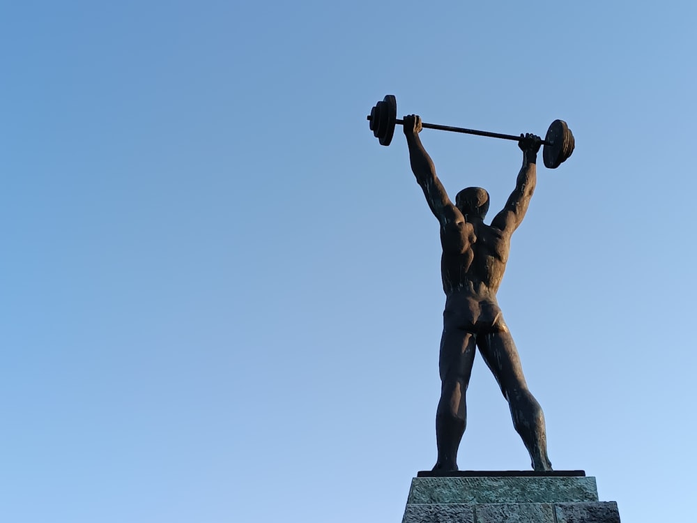 a statue of a man lifting a barbell