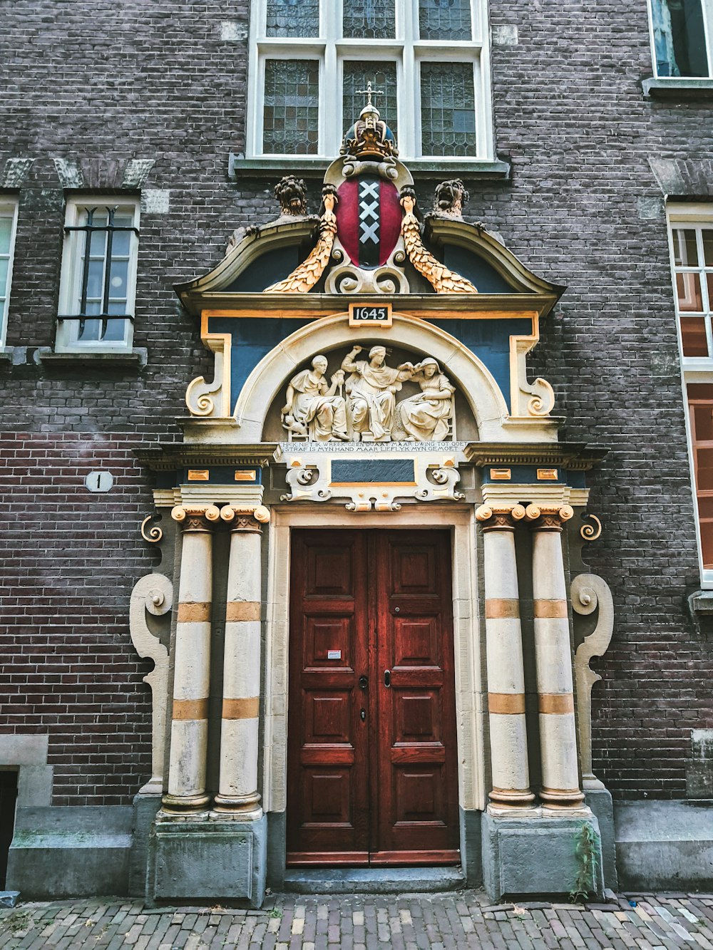 a building with a red door and a red and gold door