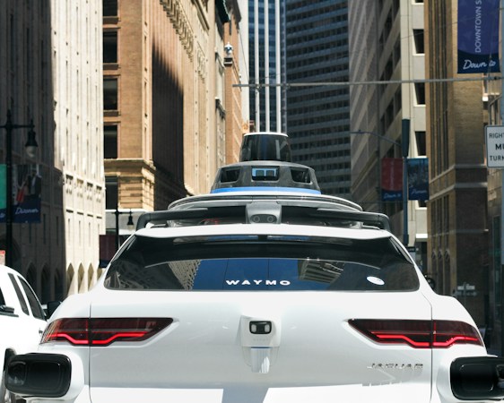 A car moving through a city street at dusk, the kind of urban driving environment Waymo's Las Vegas zone covers