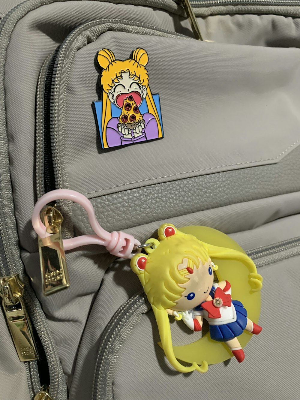 a little girl keychain attached to a backpack