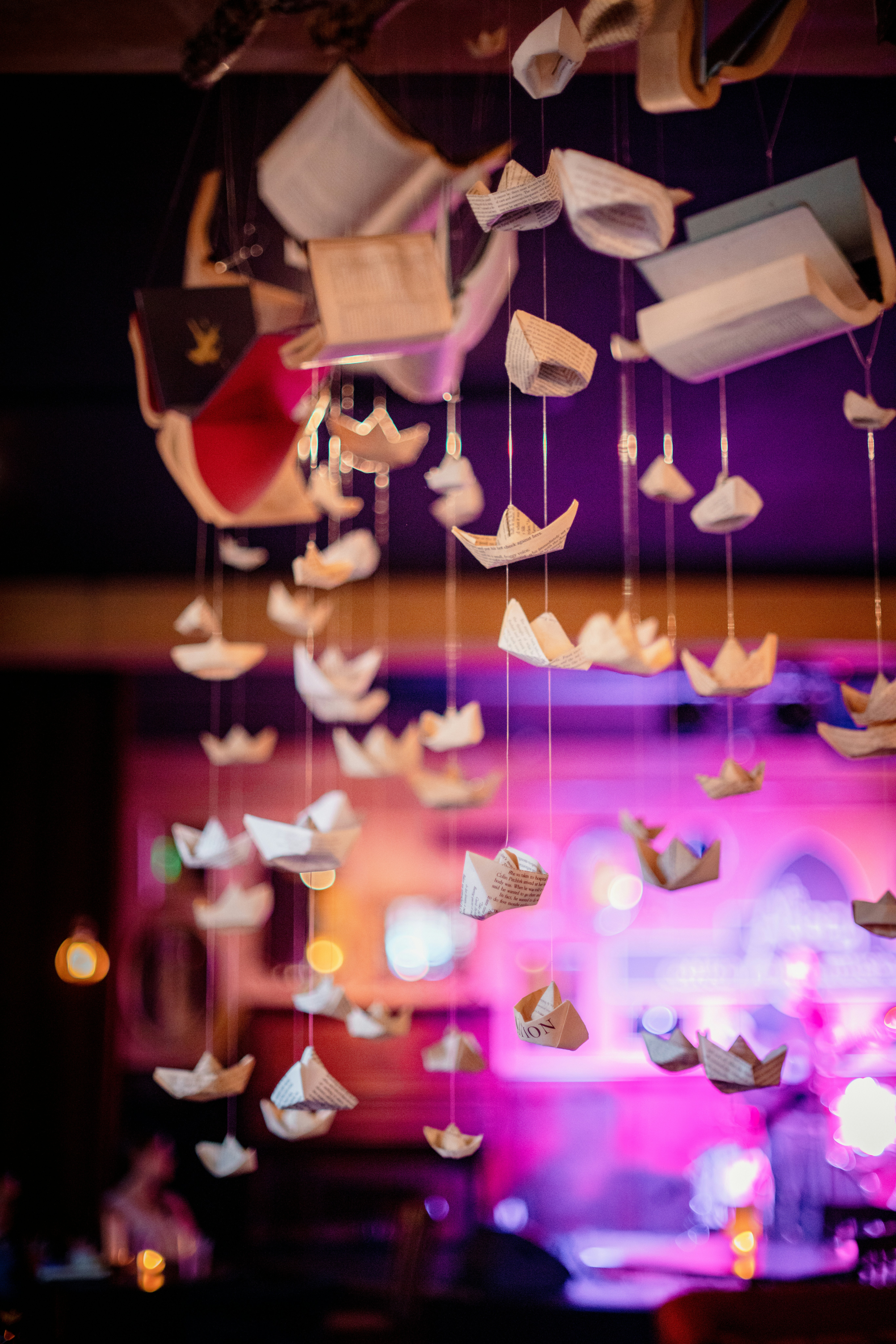 A group of paper birds hanging from a ceiling photo Free Lighting