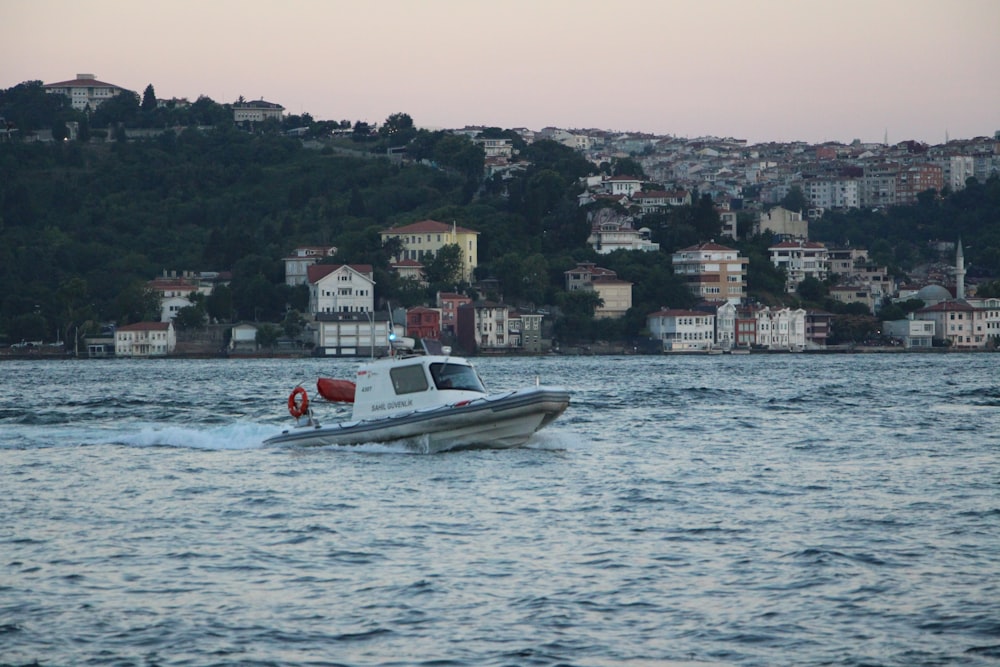 a small boat in the middle of a body of water