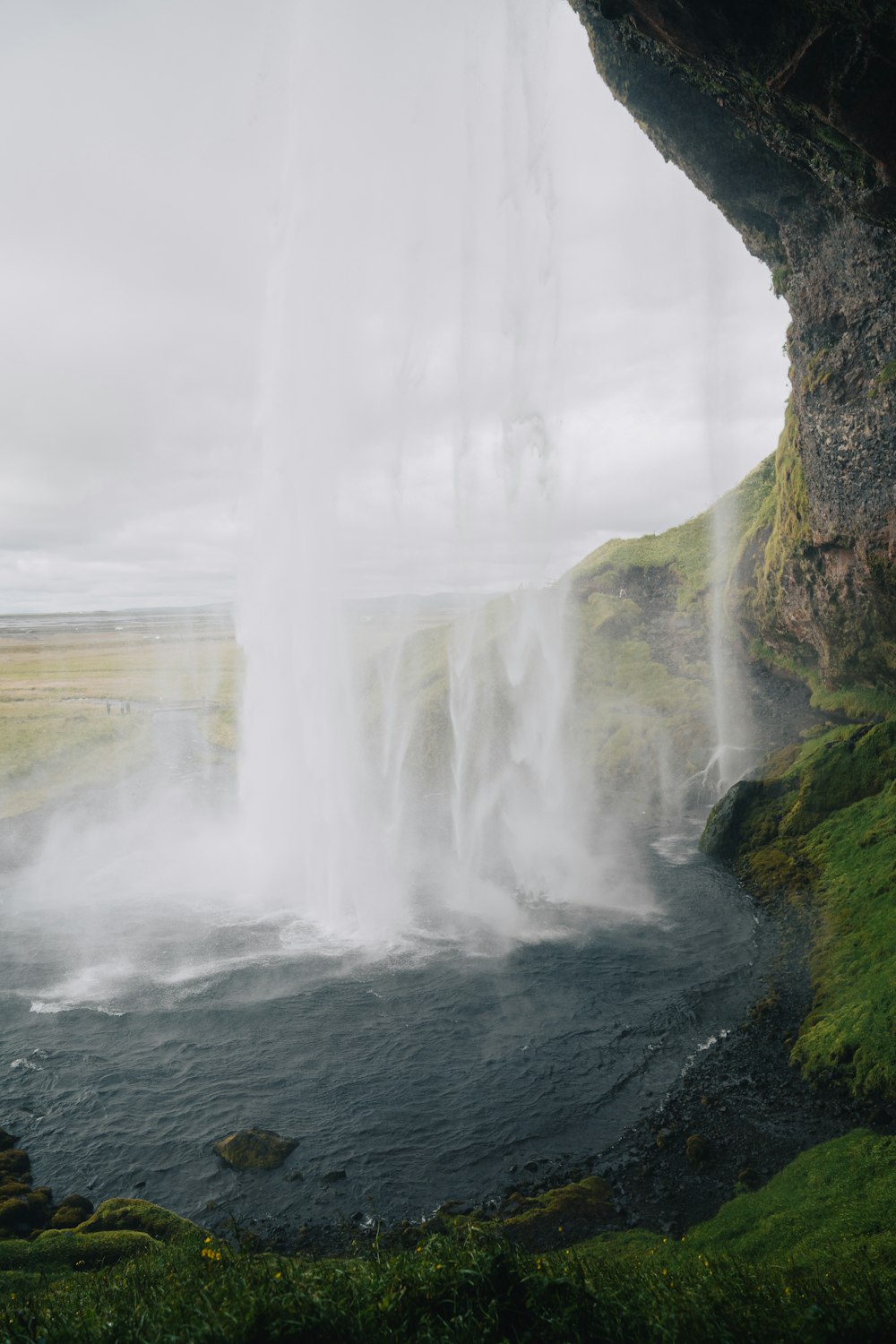a large waterfall with water coming out of it