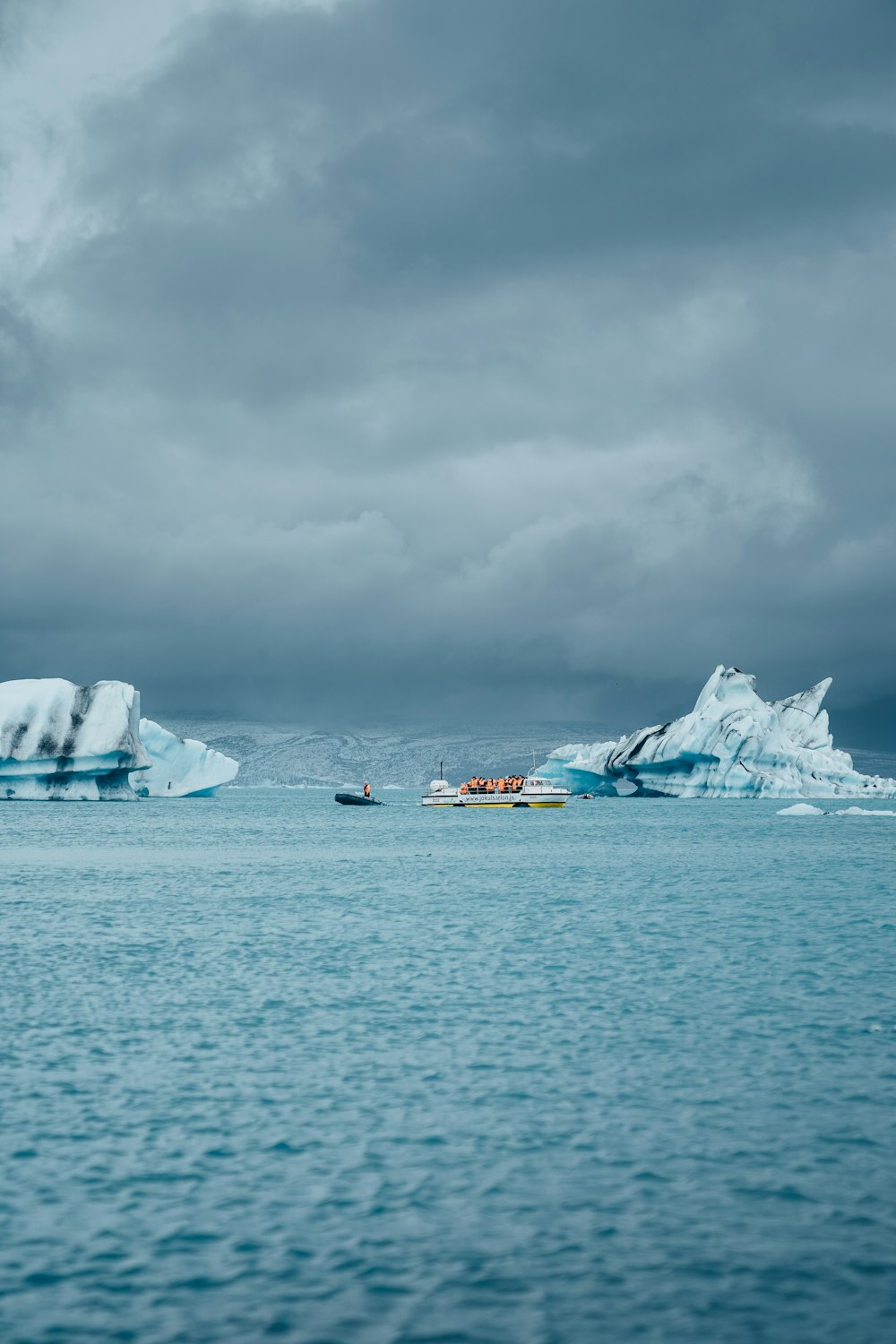 a group of icebergs floating on top of a body of water