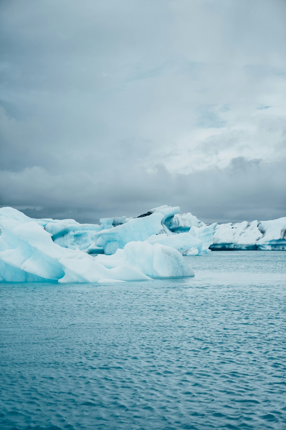 a large iceberg floating on top of a body of water