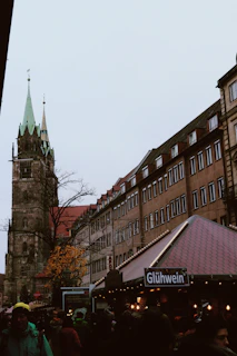A bustling Austrian market square dusted with fresh snow, locals sipping mulled wine.