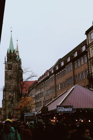 A bustling Austrian market square dusted with fresh snow, locals sipping mulled wine.