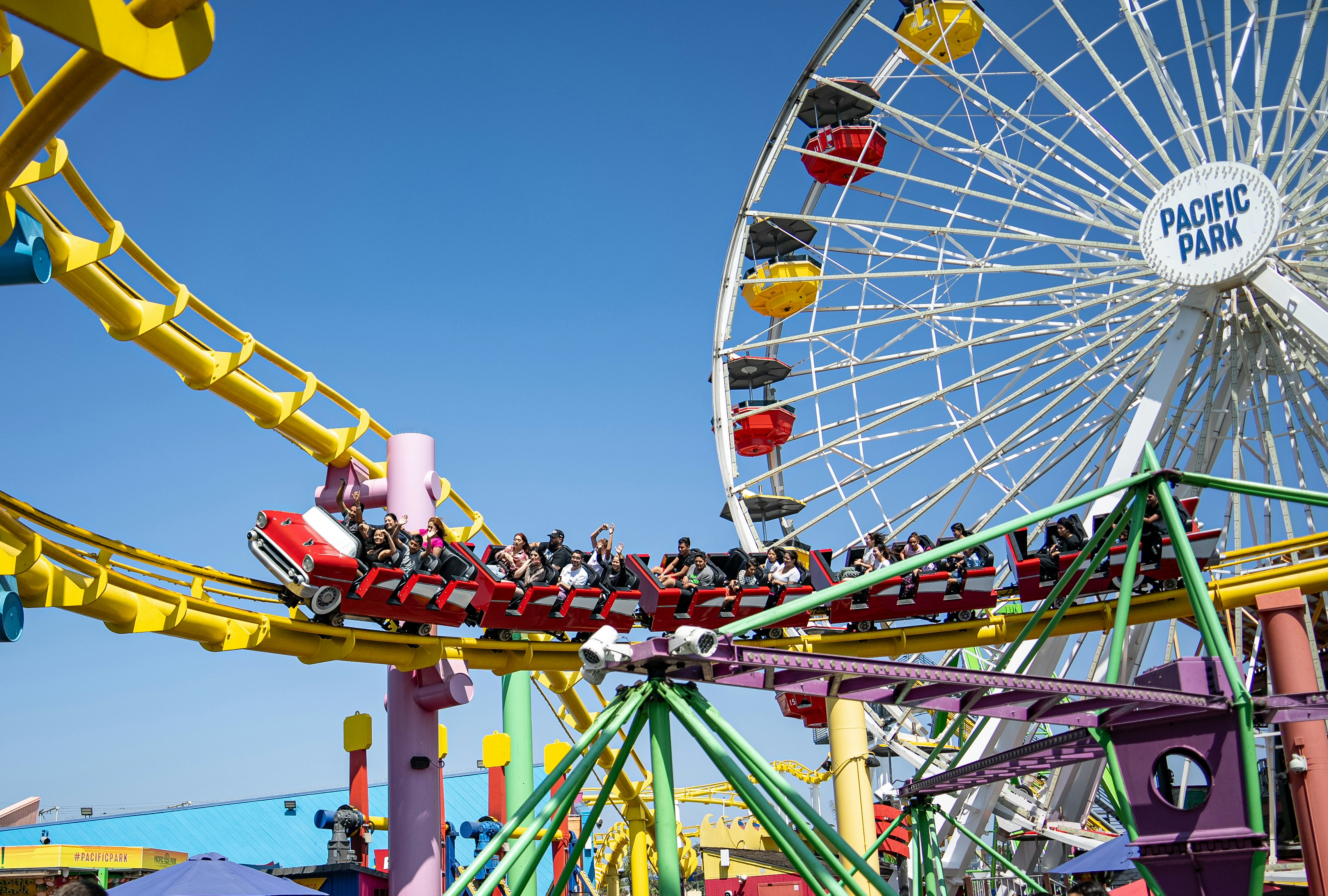 a carnival ride with a ferris wheel in the background