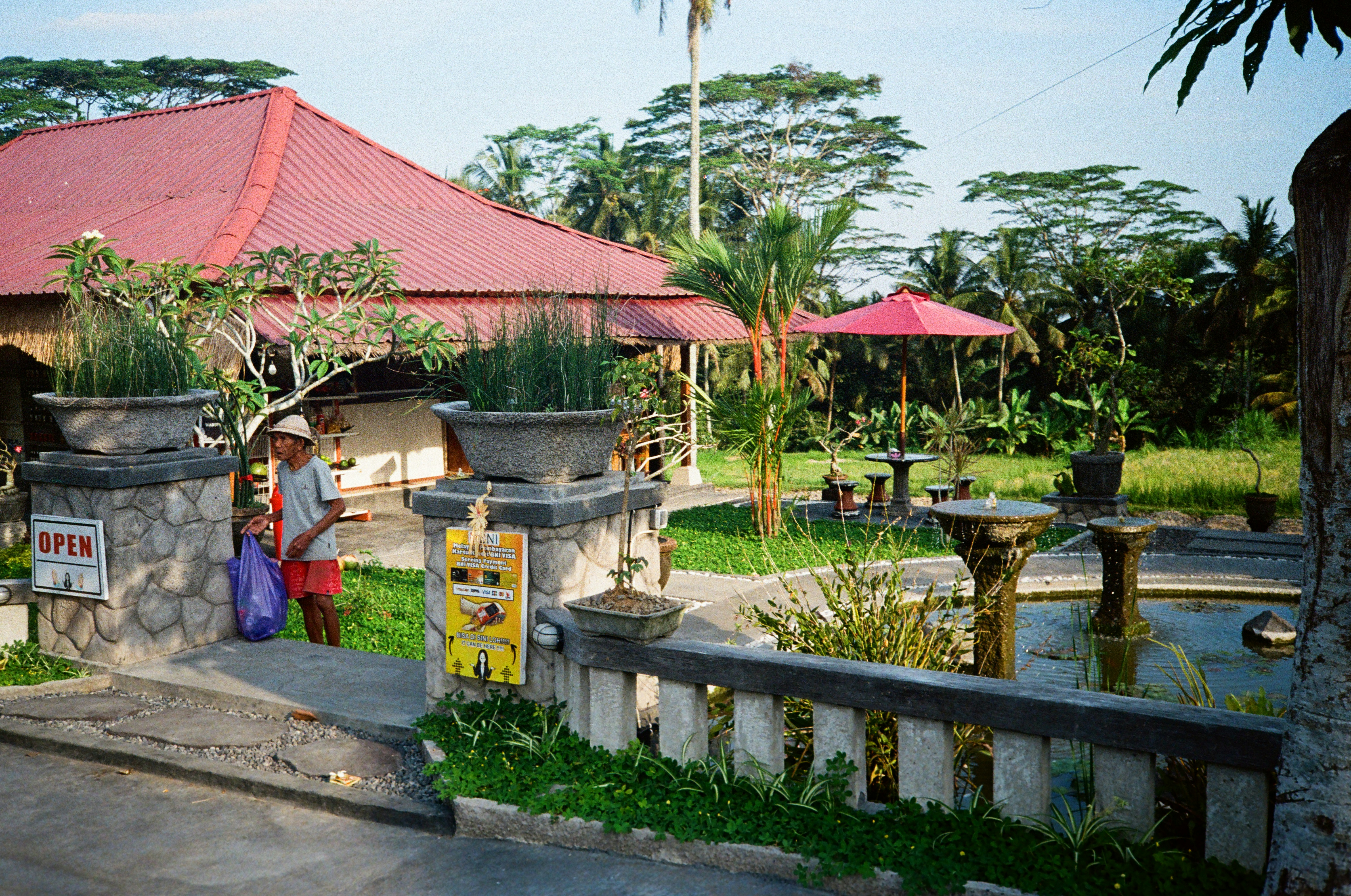 a man standing in front of a red roof