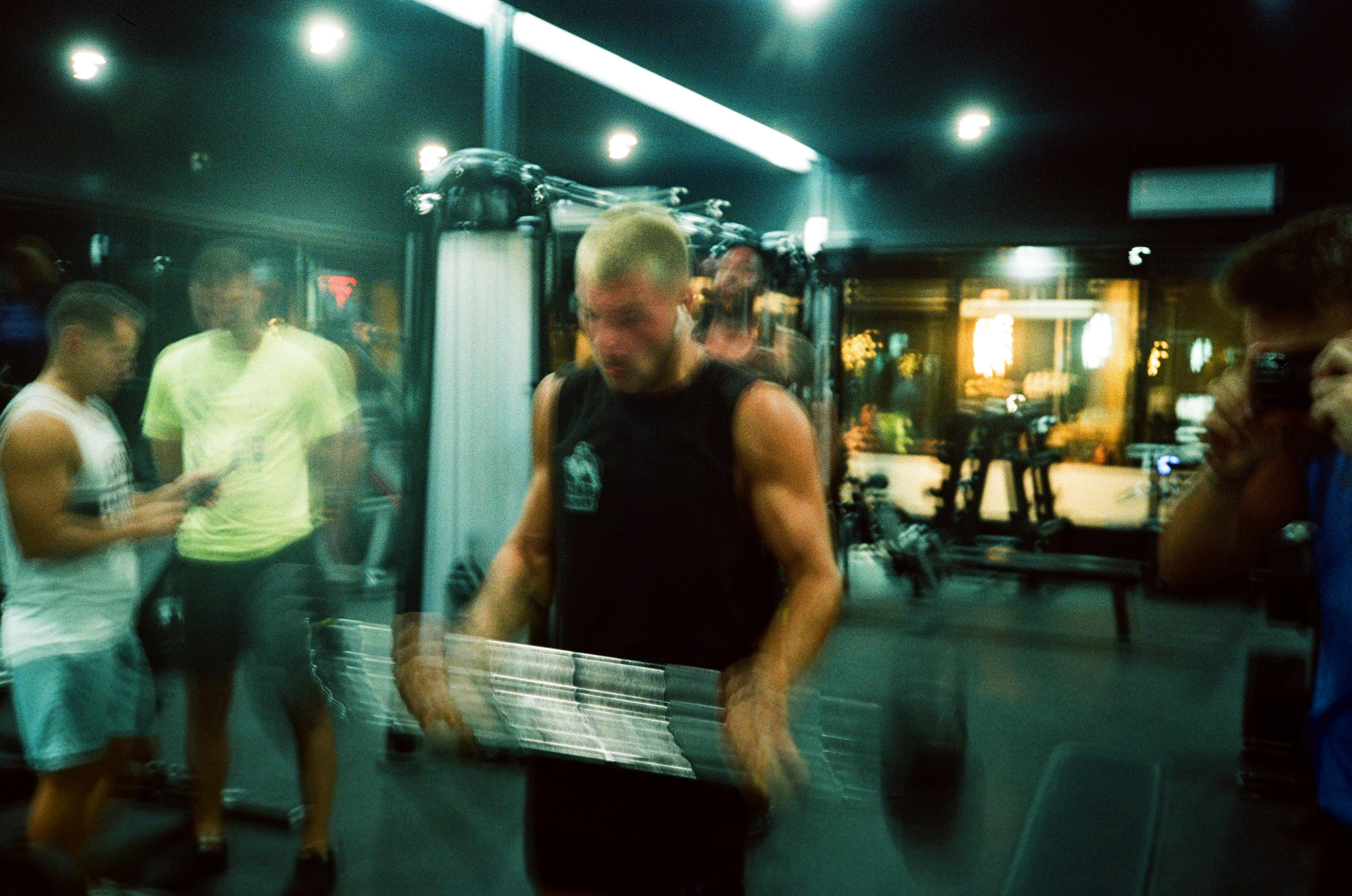 a man holding a box in a gym