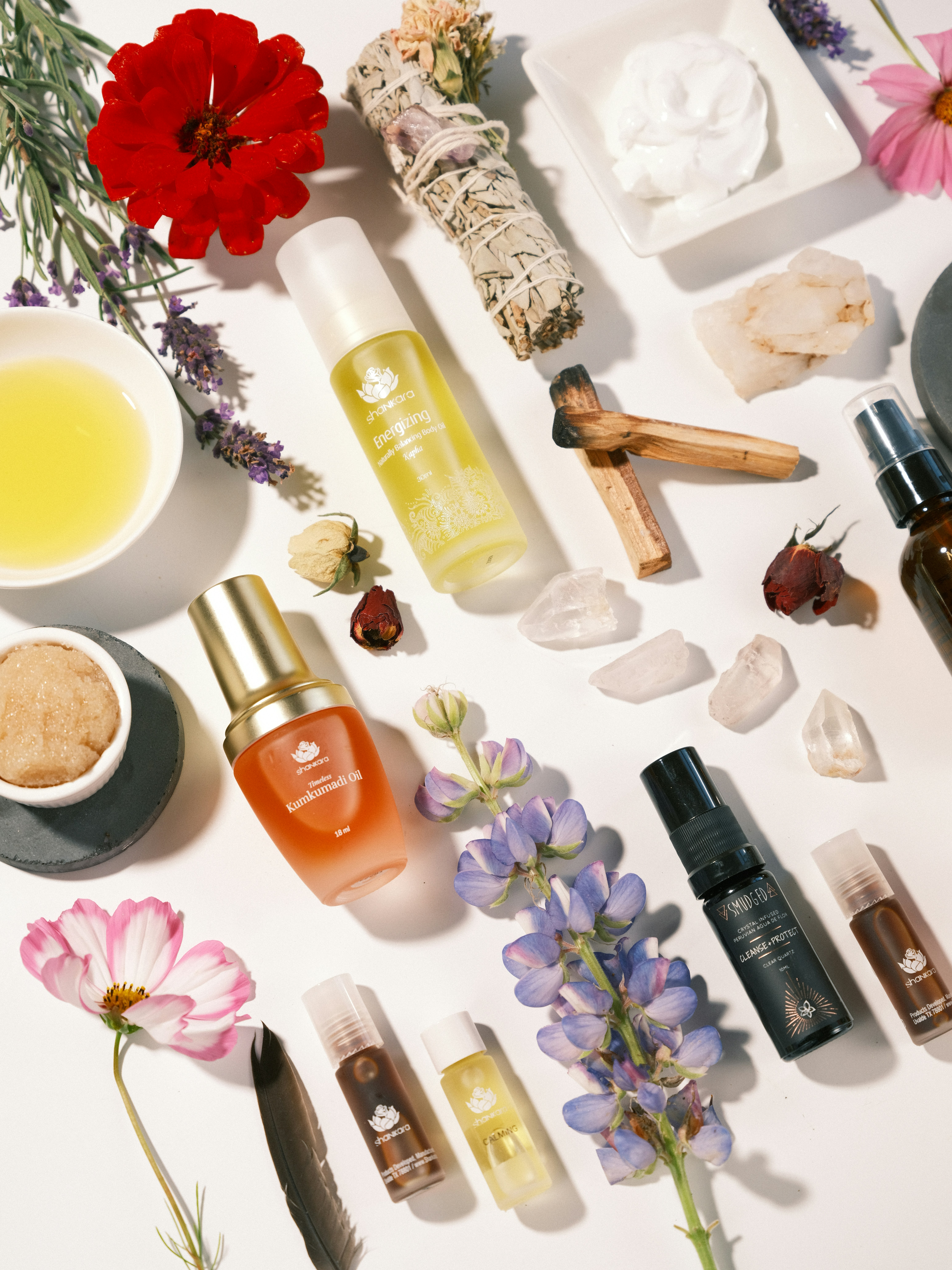 a white table topped with bottles of different types of skin care products