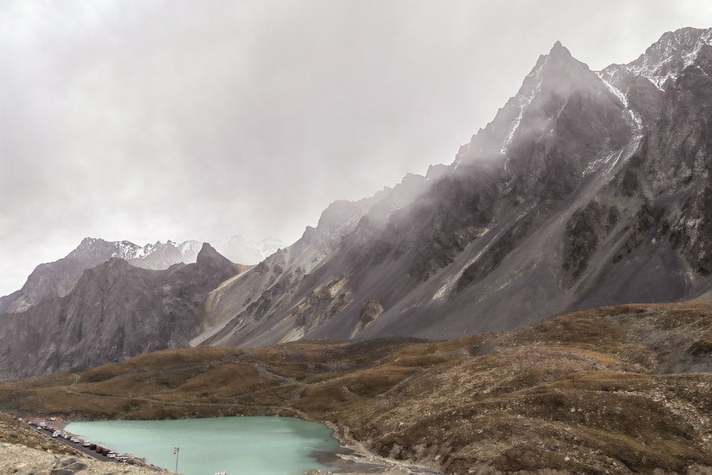 a mountain range with a body of water in the foreground