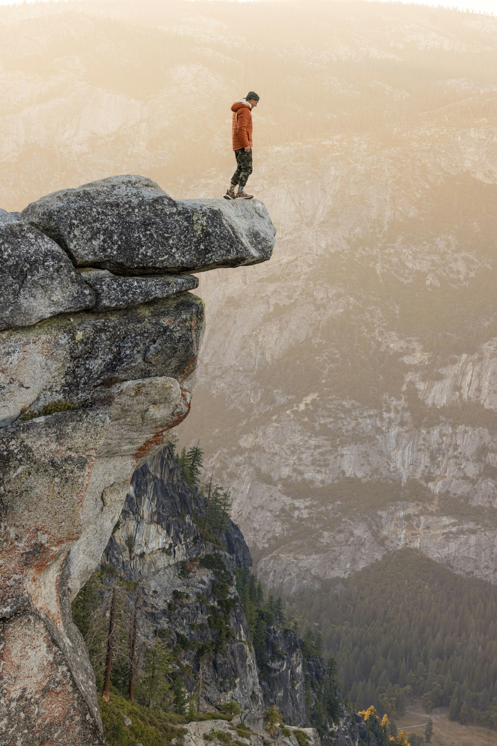 a man standing on top of a cliff