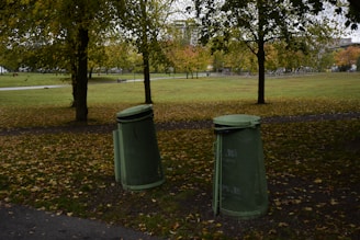 Clean public park with trash bins and people enjoying the space.