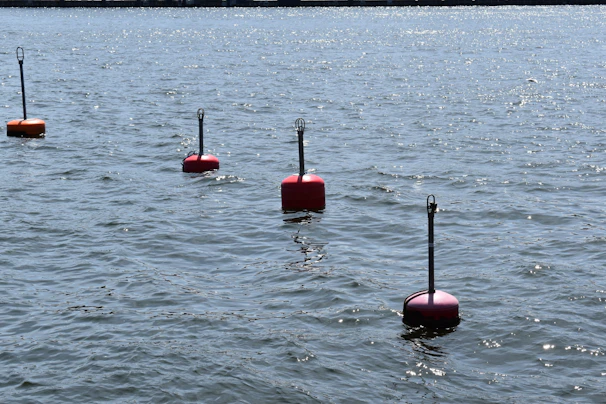Vibrant orange race buoys marking the route against the deep navy ocean backdrop.