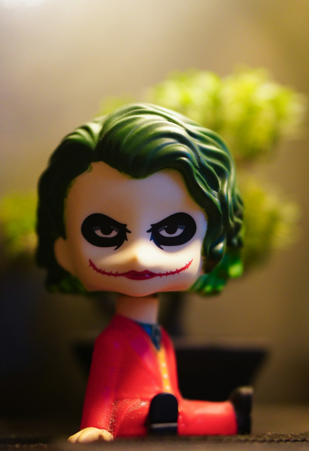 a close up of a toy with a green hair