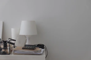 Close-up of a minimalist desk organizer holding cables, notebooks, and a wireless charger.