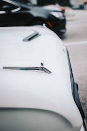 Close-up of a corporate fleet vehicle with partial vinyl cut decals on the doors and hood.