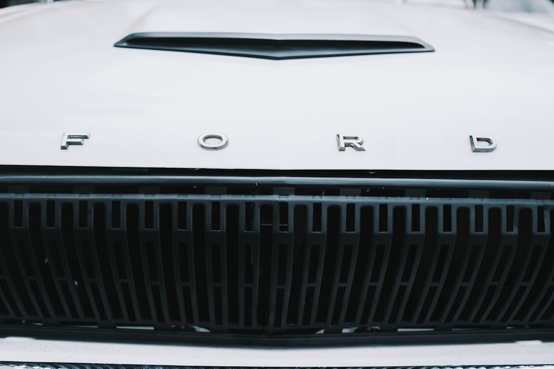 a close up of the front grill of a white car,