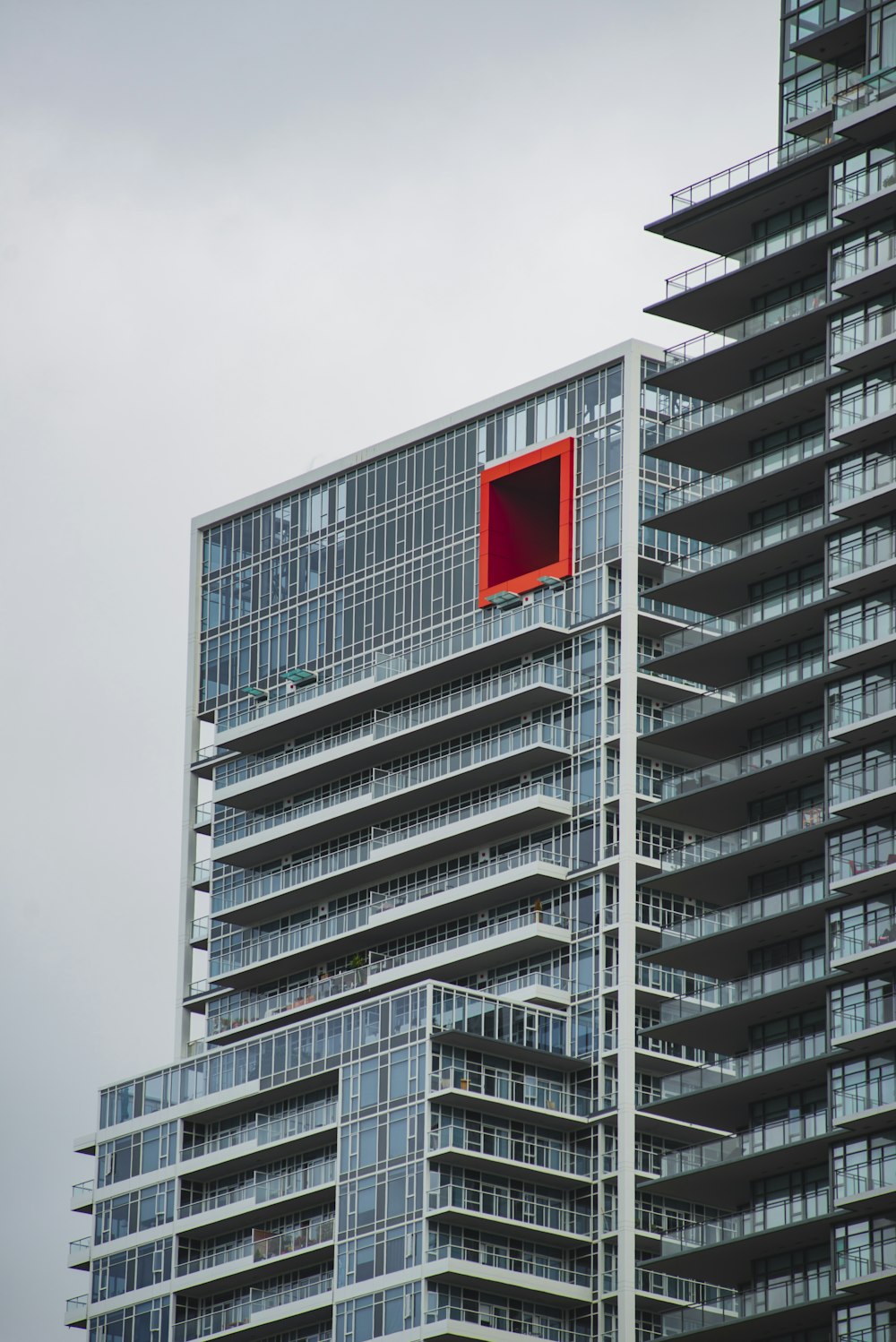 a tall building with a red square in the middle of it