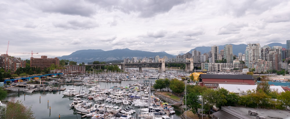 a harbor filled with lots of boats under a cloudy sky