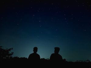 A whimsical sketch of Enki and Enlil sharing a quiet moment under a starlit sky.