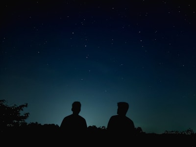 A whimsical sketch of Enki and Enlil sharing a quiet moment under a starlit sky.